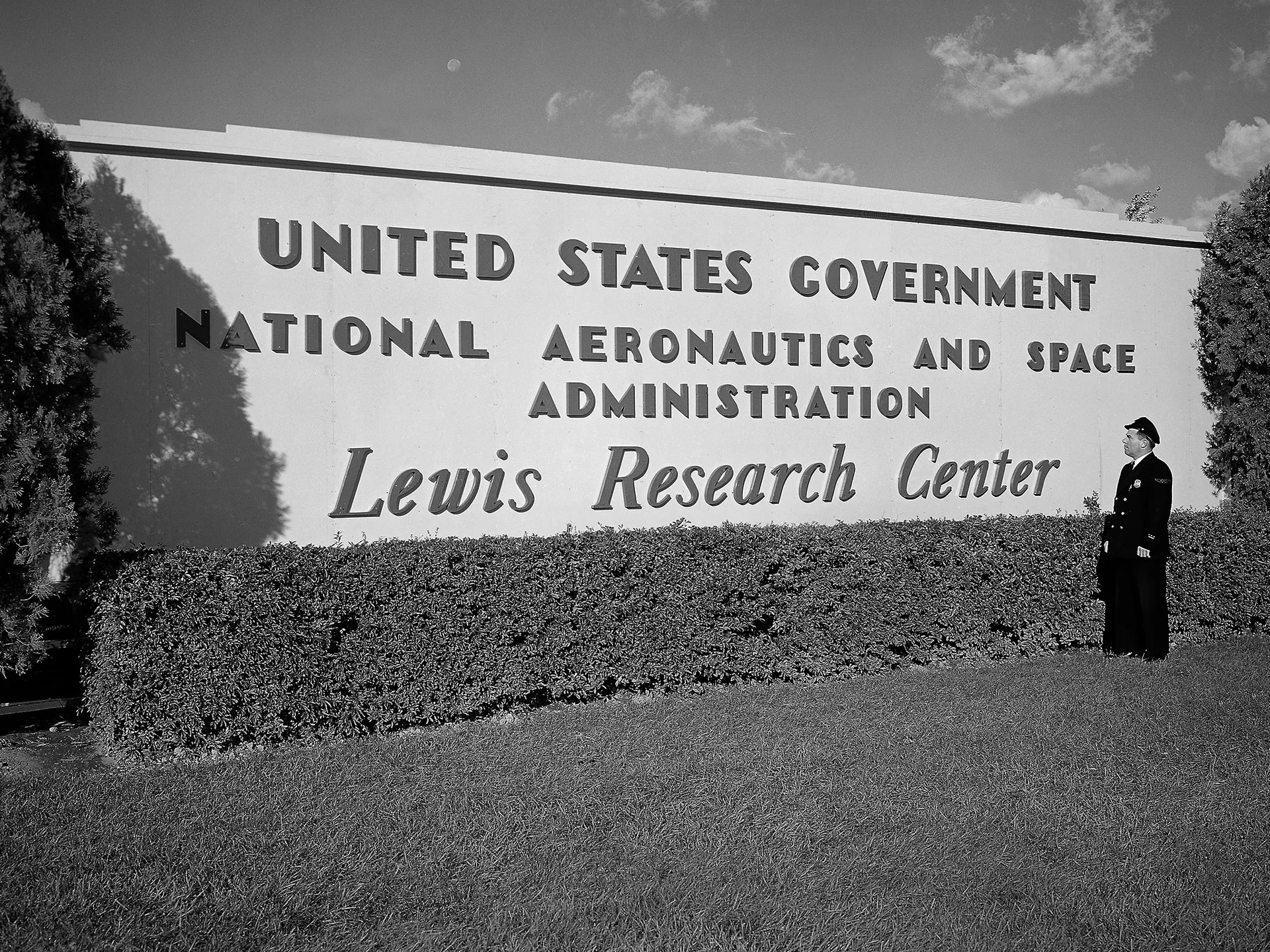 A guard stands beside the new NASA Lewis Research Center sign.