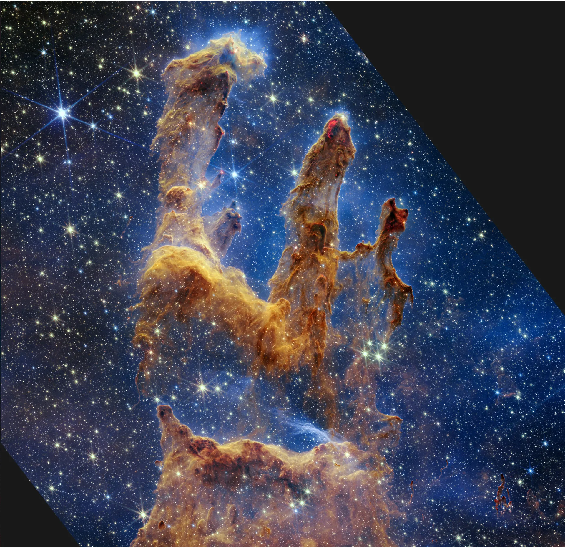 The same columns in orange and gold, more translucent, against a deep blue field crowded with thousands of stars.