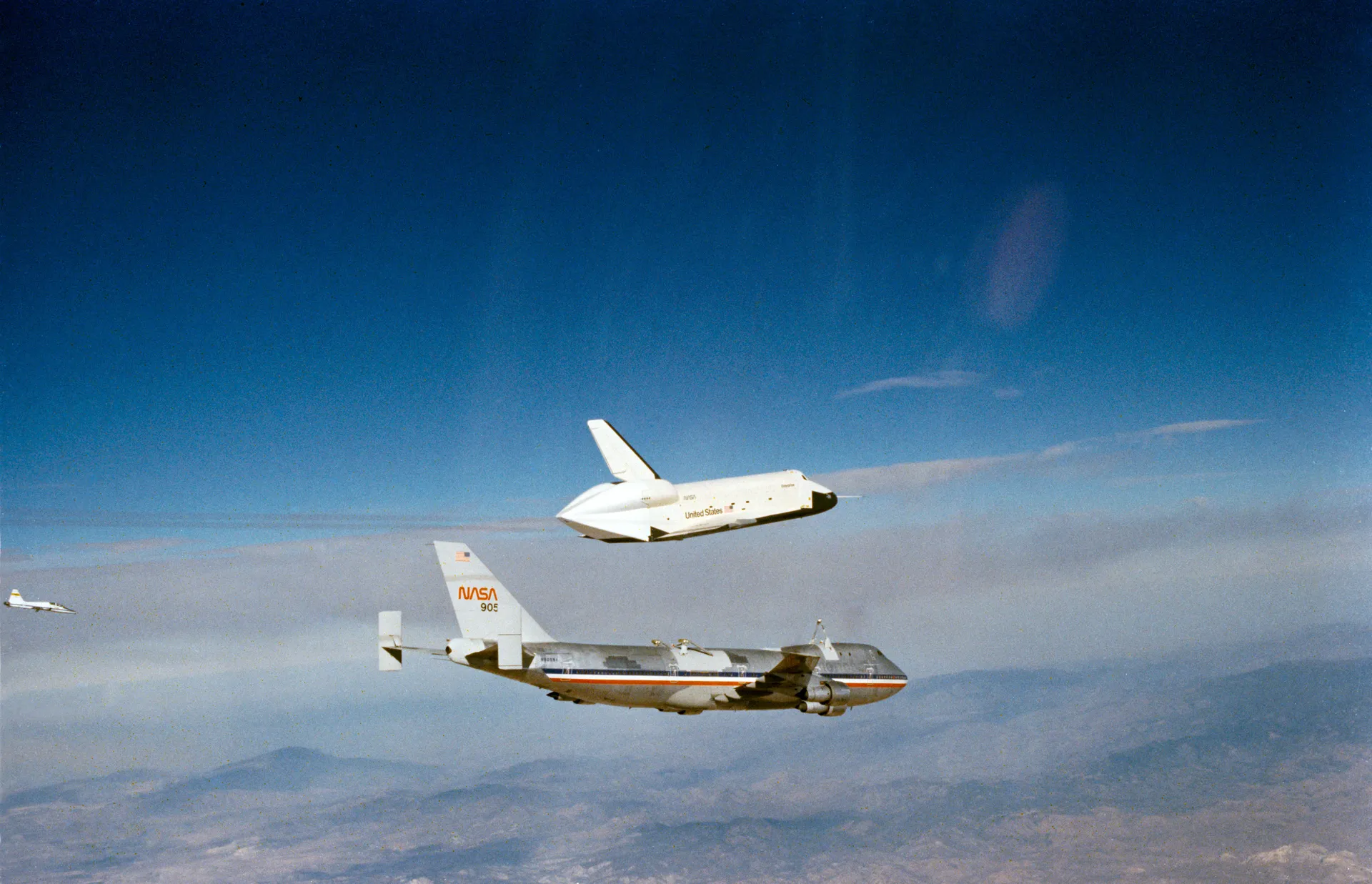 The orbiter Enterprise separates from the top of its Boeing 747 carrier high above the desert.