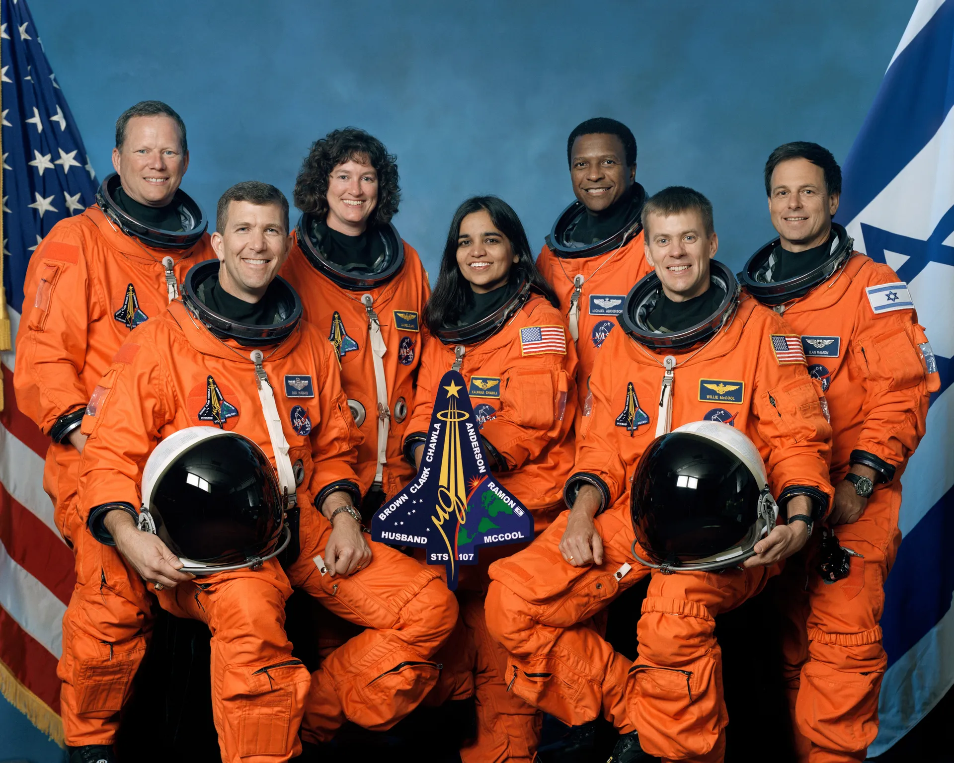 The seven STS-107 astronauts in orange launch-and-entry suits.