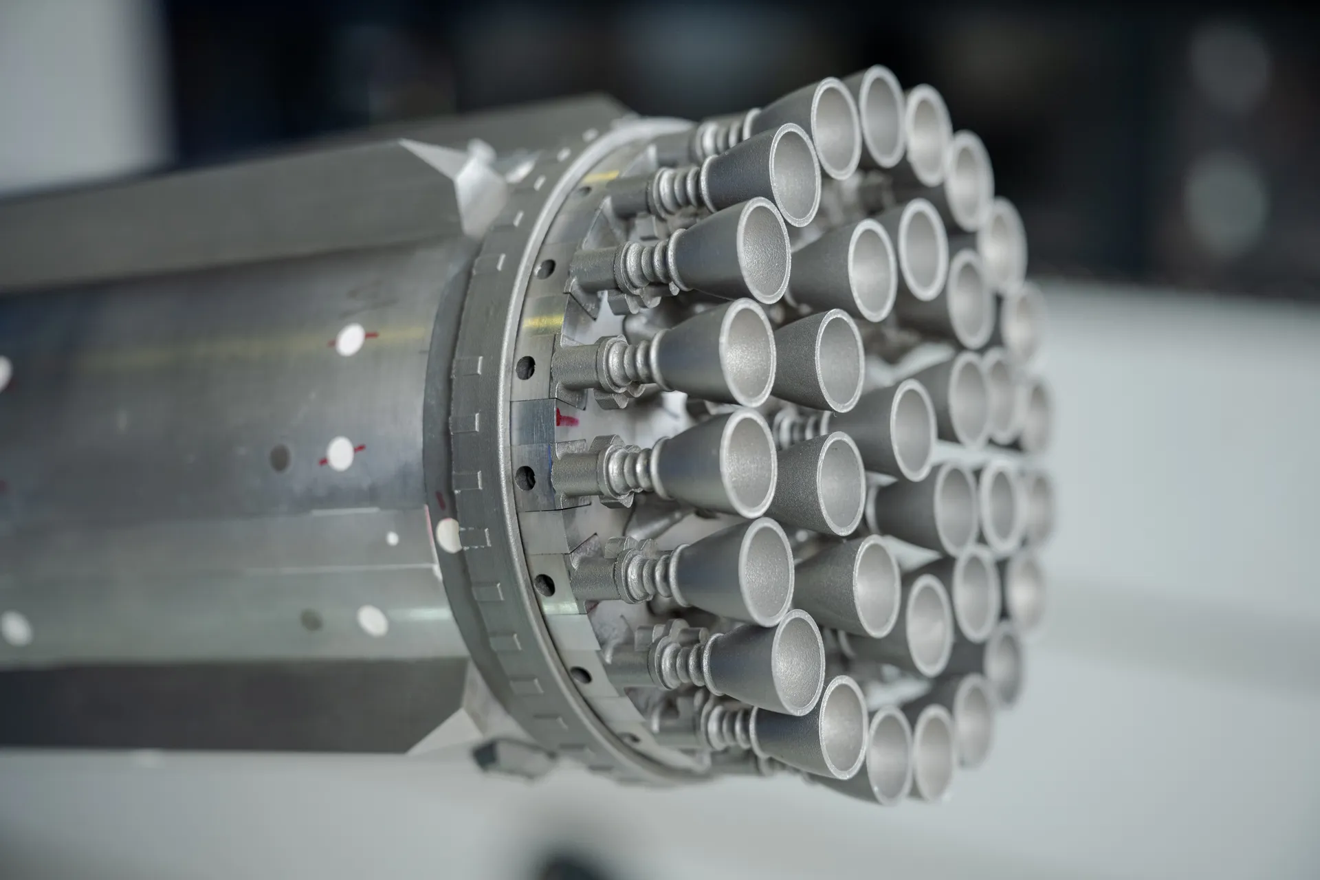 Close-up of a metal scale model’s base: dozens of small engine nozzles in concentric rings.